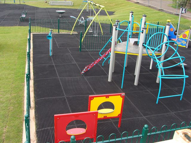 Rubber grass mats on large playground