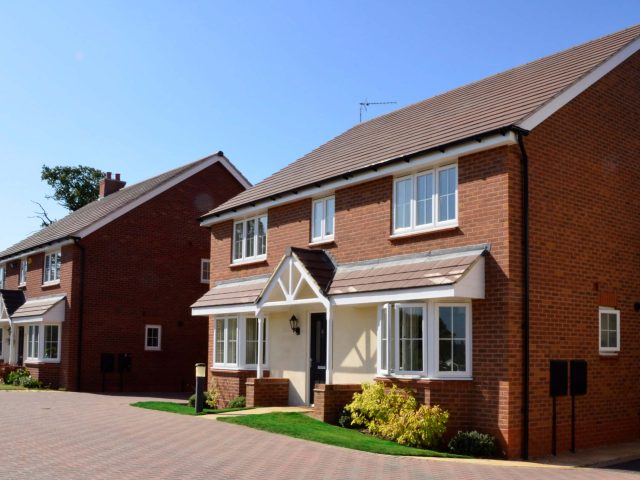 Residential housing with small grass lawns