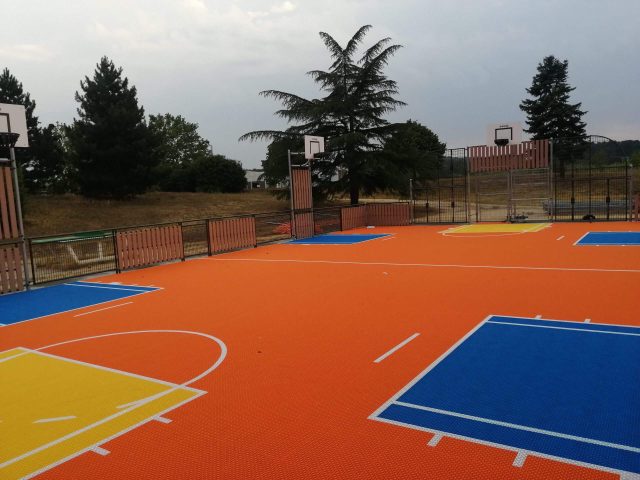 FlexCourt's modular sport surface installed in a large multi-use sports court