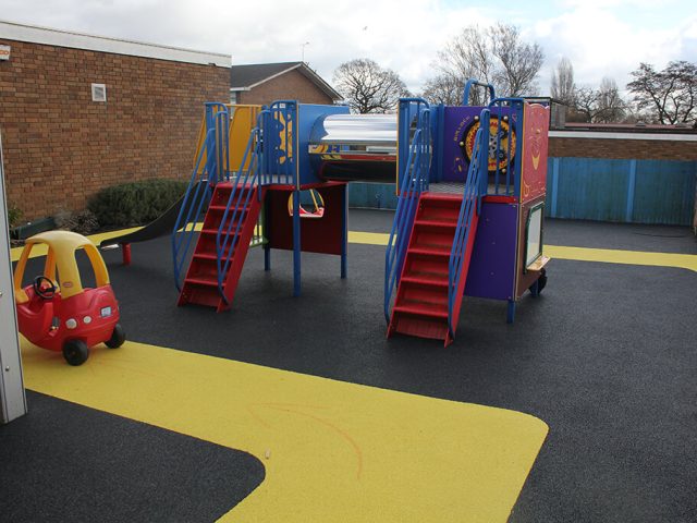 Black and yellow roadway rubber surfacing in a school