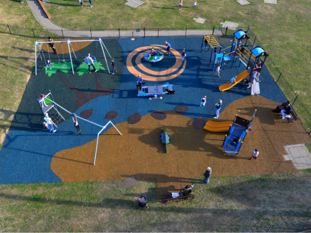 Bending Cresent Playground installation with forest and beach design colourful rubber surfaces