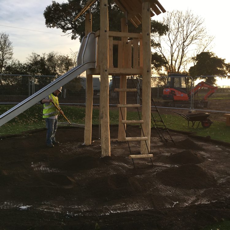 Fill holes with topsoil then lay 25mm topsoil and grass seed over the top of the shock pad