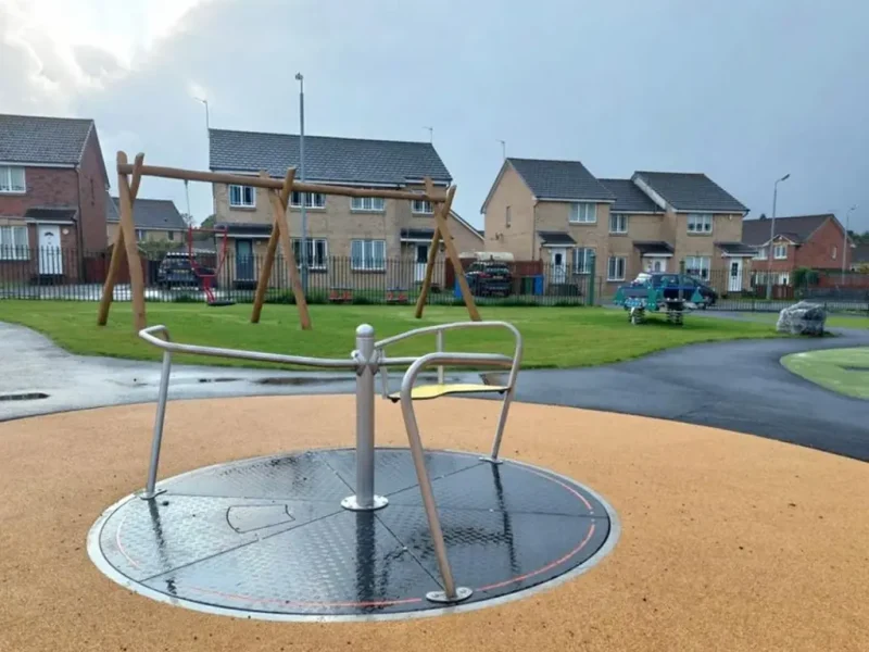 Corkeen surrounding an inclusive roundabout in a play area of a housing development