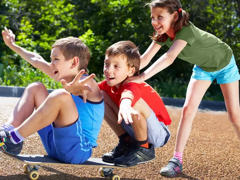 Children playing safely on a skateboard on Corkeen surfacing