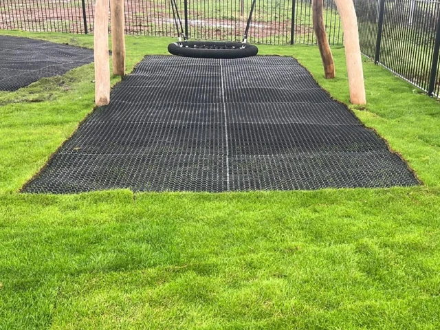 visible grass mat under wooden playground equipment