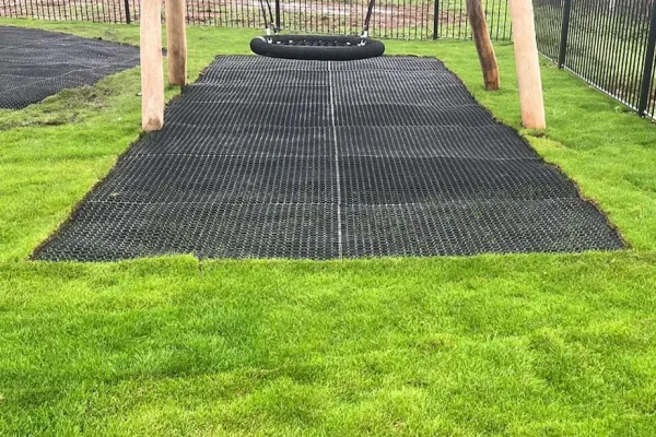 visible grass mat under wooden playground equipment