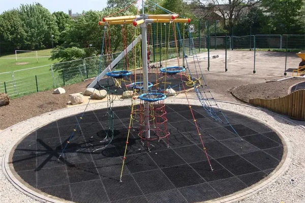 Circular EcoSmart safety flooring under large climbing frame for enhanced CFH safety