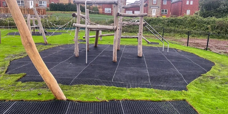 EcoSmart grass protector matting underneath wooden playground equipment