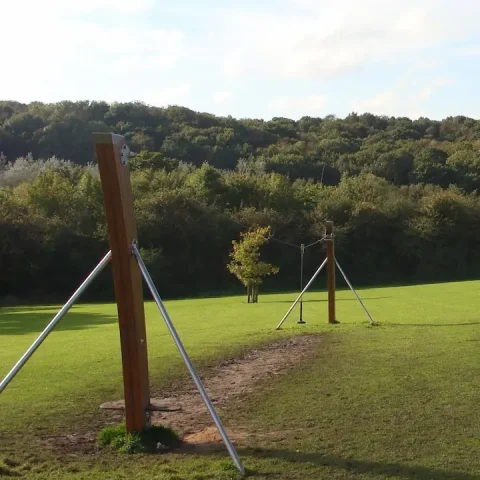Worn ground underneath playground zip line before EcoSmart installation