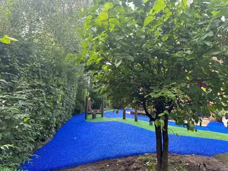 Vibrant blue and green EPDM Mulch play area at Studley school