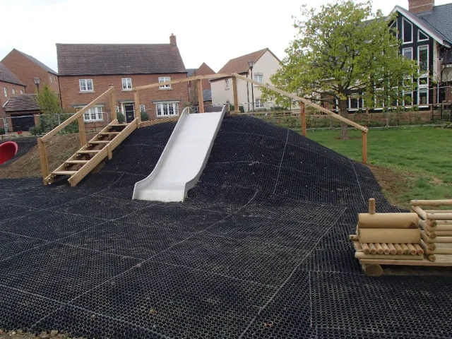 Fire Retardant GrassMats in wooden playground