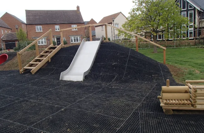 Fire Retardant GrassMats in wooden playground