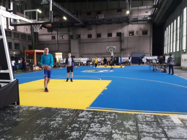 FlexCourt's modular sport surface with custom sports markings installed in a large indoor basketball court
