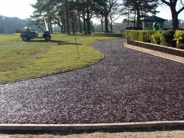 Golf course with golf buggy and rubber mulch pathway