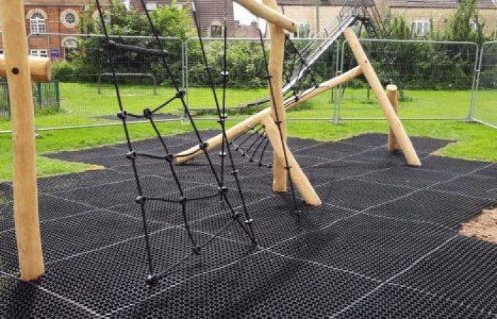 Visible grass mat under wooden playground equipment