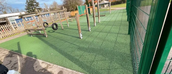 Green EPDM Rubber play area under wooden trim trail equipment