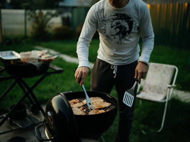 Man grilling meat on a Barbecue