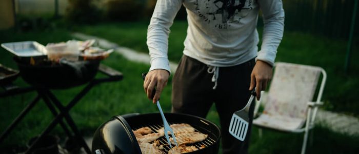 Man grilling meat on a Barbecue