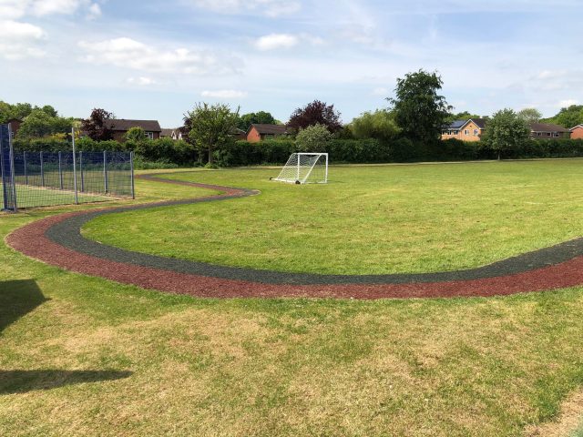 Boothwood Primary Red and Black Rubber Mulch Running Track Installation