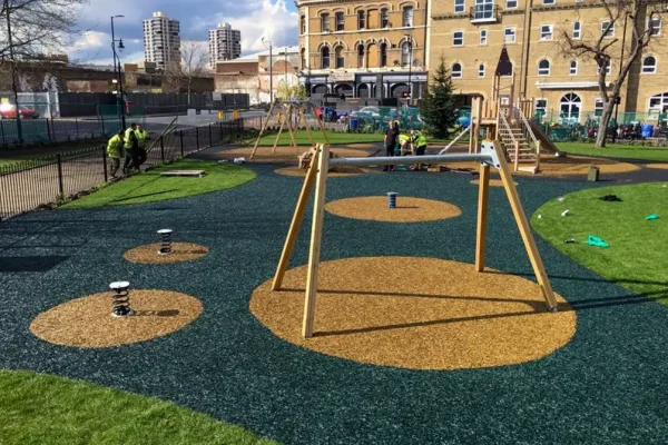Rubber Mulch Playground with dark blue base and yellow circles around equipment