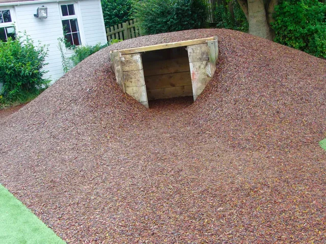 JungleMulch on mound with wooden den