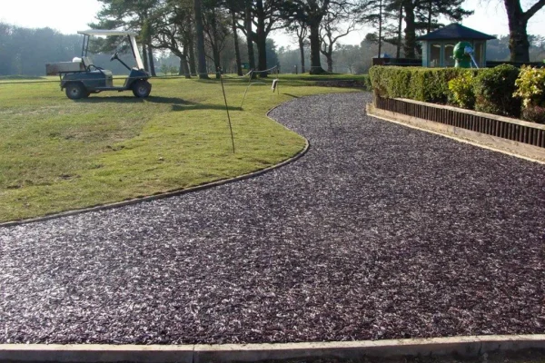 Golf course with golf buggy and rubber mulch pathway