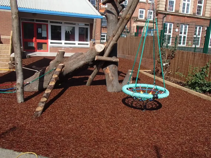 Original JungleMulch flooring to a bucket swing in a school play aera