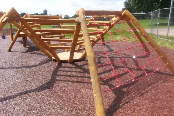 Original JungleMulch providing safety below a wooden spider climber in a play area