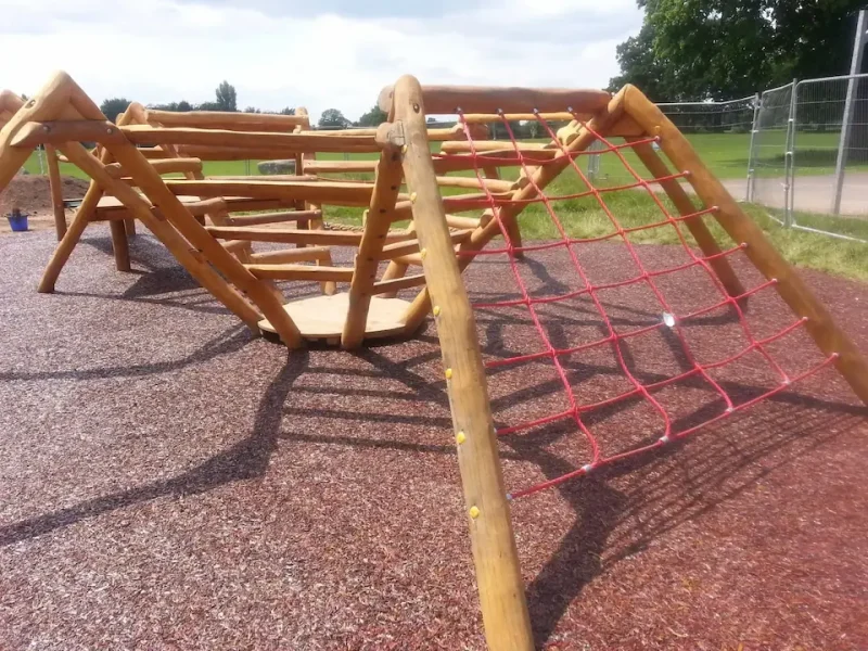 Original JungleMulch providing safety below a wooden spider climber in a play area