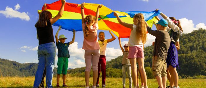 Children playing outside with a parachute game