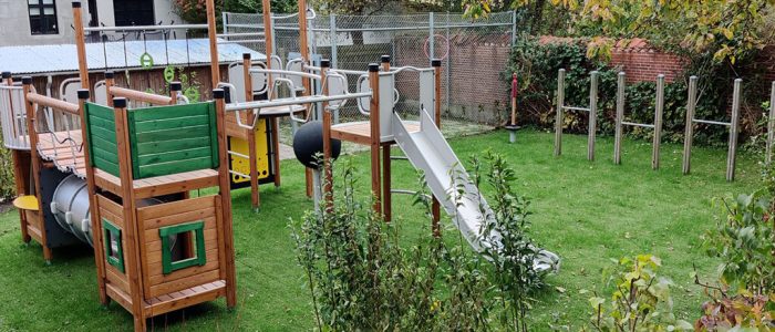 Hybrid grass safety surfacing underneath playground equipment