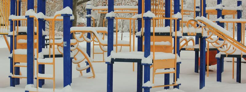 Climbing frame playground covered in snow