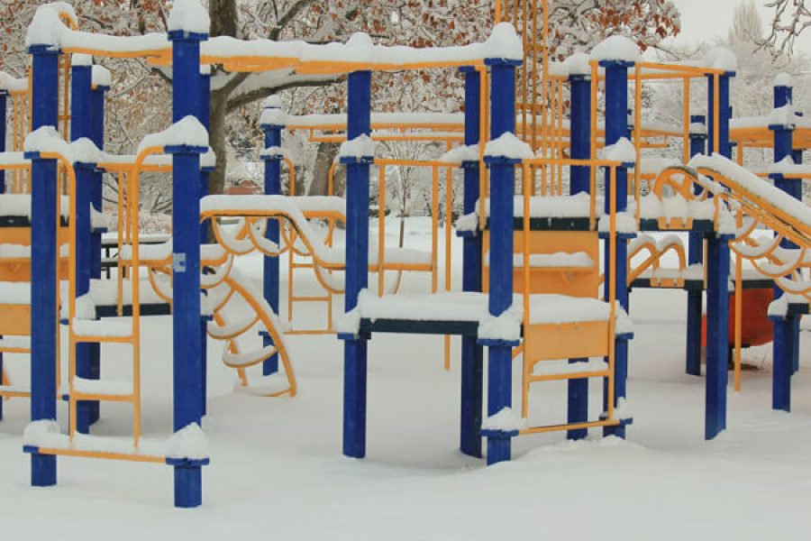 Climbing frame playground covered in snow