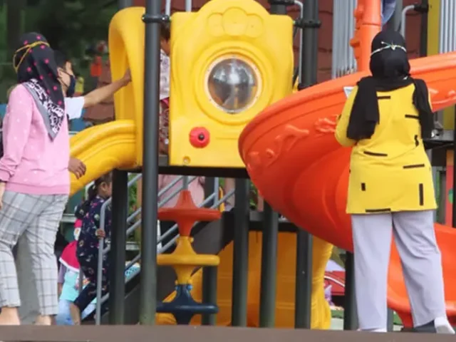 children playing around a play tower