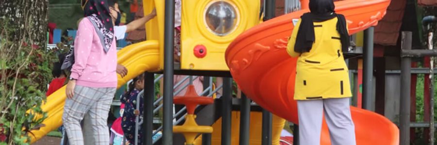 Children playing around a play tower