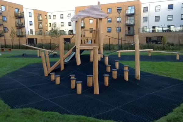 Rubber grass mat surfacing on a hill around obstacle course