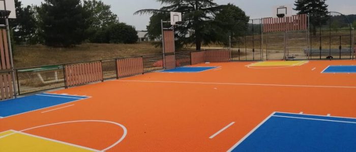 Flexcourt MUGA in orange with blue, white and yellow markings