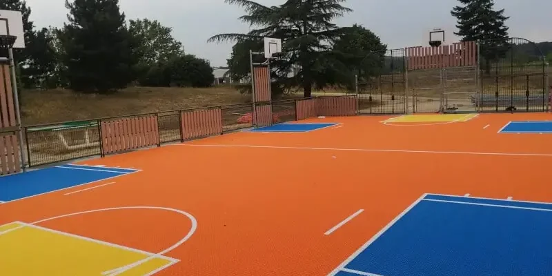 Flexcourt MUGA in orange with blue, white and yellow markings