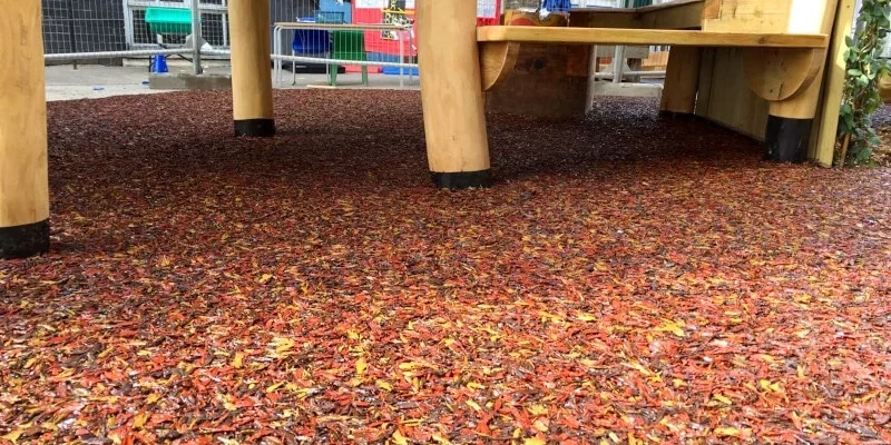 PlaySmart’s Jungle Mulch bonded rubber mulch outdoor play surfacing solution in Autumnal shades of red, yellow, orange and brown.