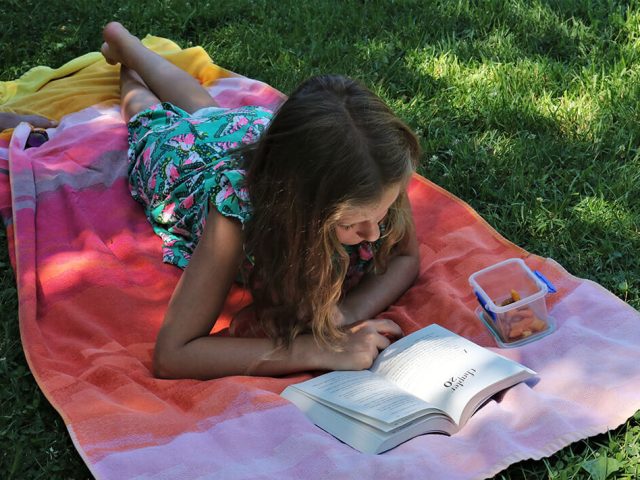 Child reading outdoors