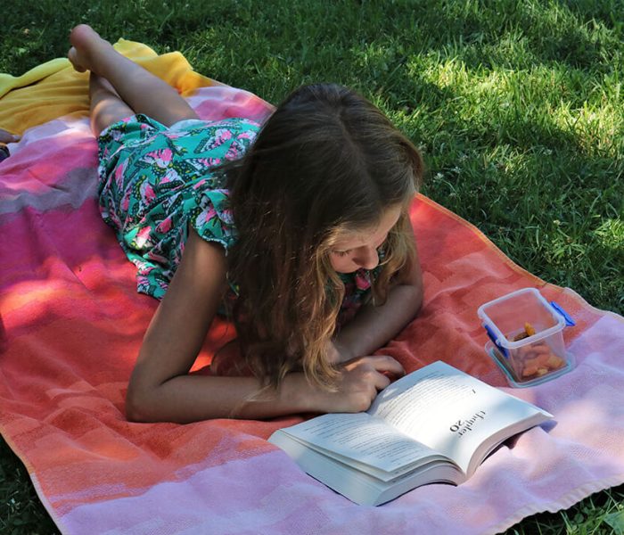 Child reading outdoors