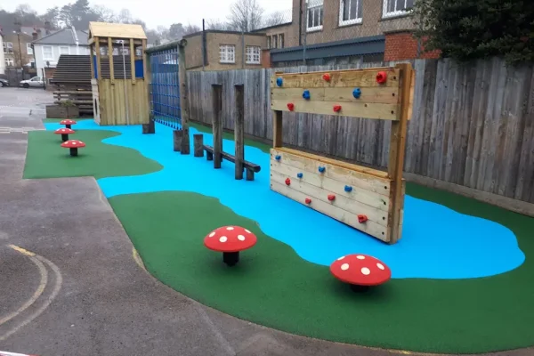River design playground safety surfacing with green and blue RubbaSmart wetpour