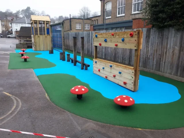 River design playground safety surfacing with green and blue RubbaSmart wetpour