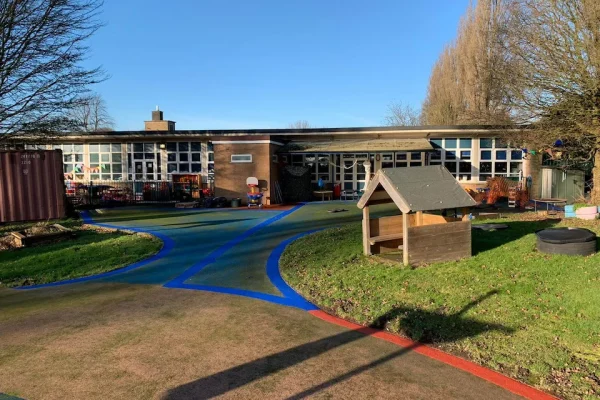 Playsmart’s rubber surfacing used on a playground in blue and sand-coloured rubber mulch colours