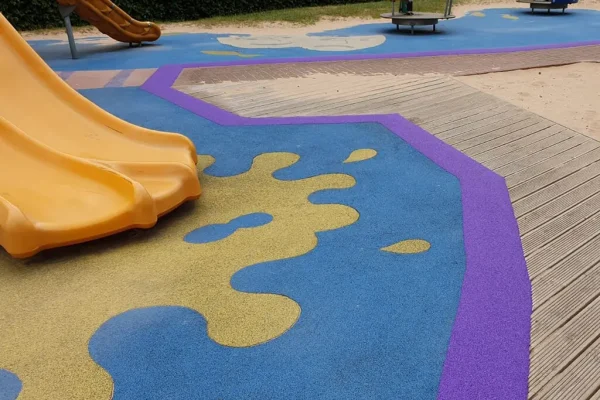 Rubber surface with purple EPDM rubber band around the edges and yellow EPDM wear pad at the base of a slide