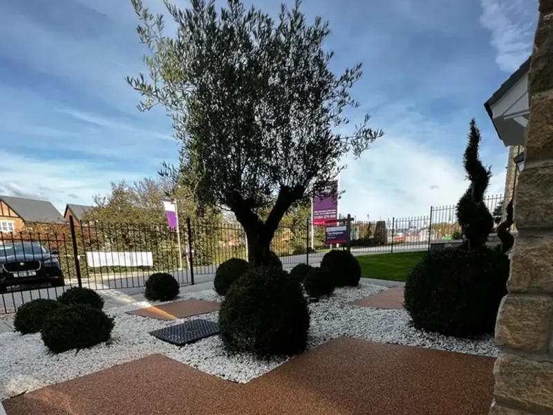 Stylish topiary garden of a housing development with Corkeen pathways